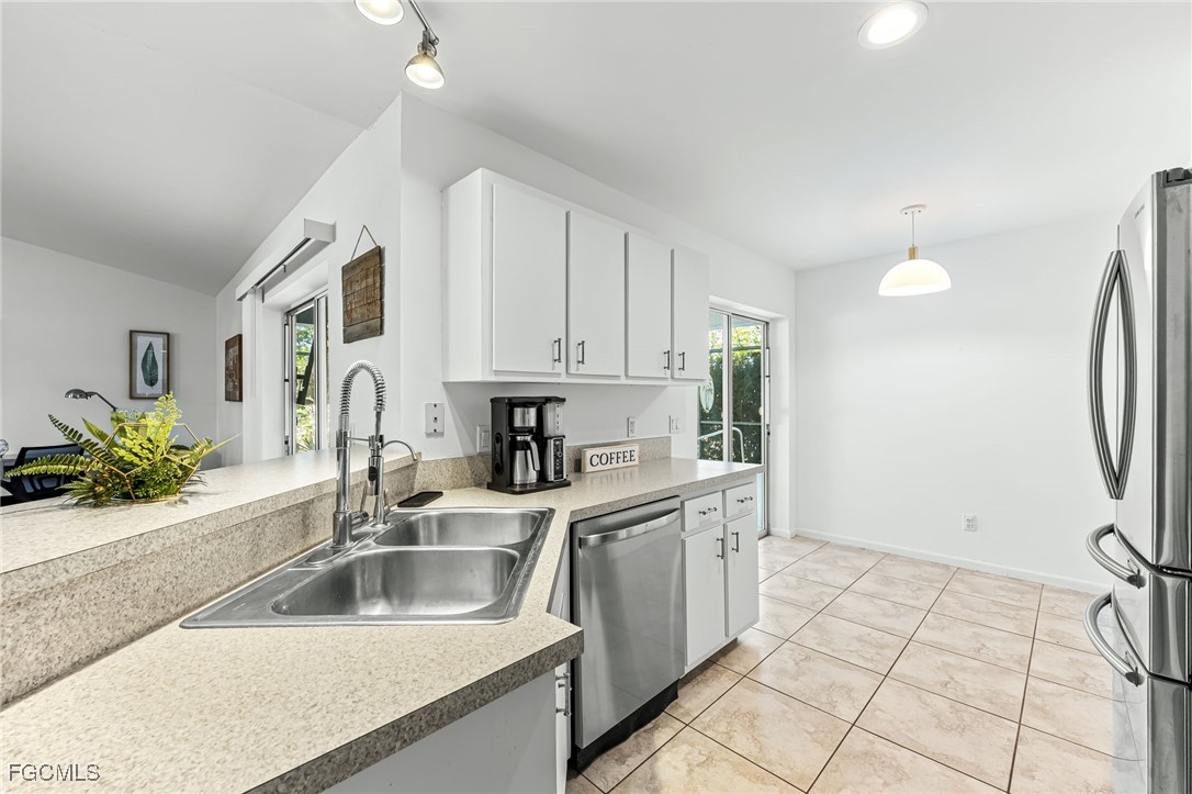 8468 Grove Road Fort Myers, FL 33967 - Photo 8 of 24 a kitchen with a sink and a refrigerator
