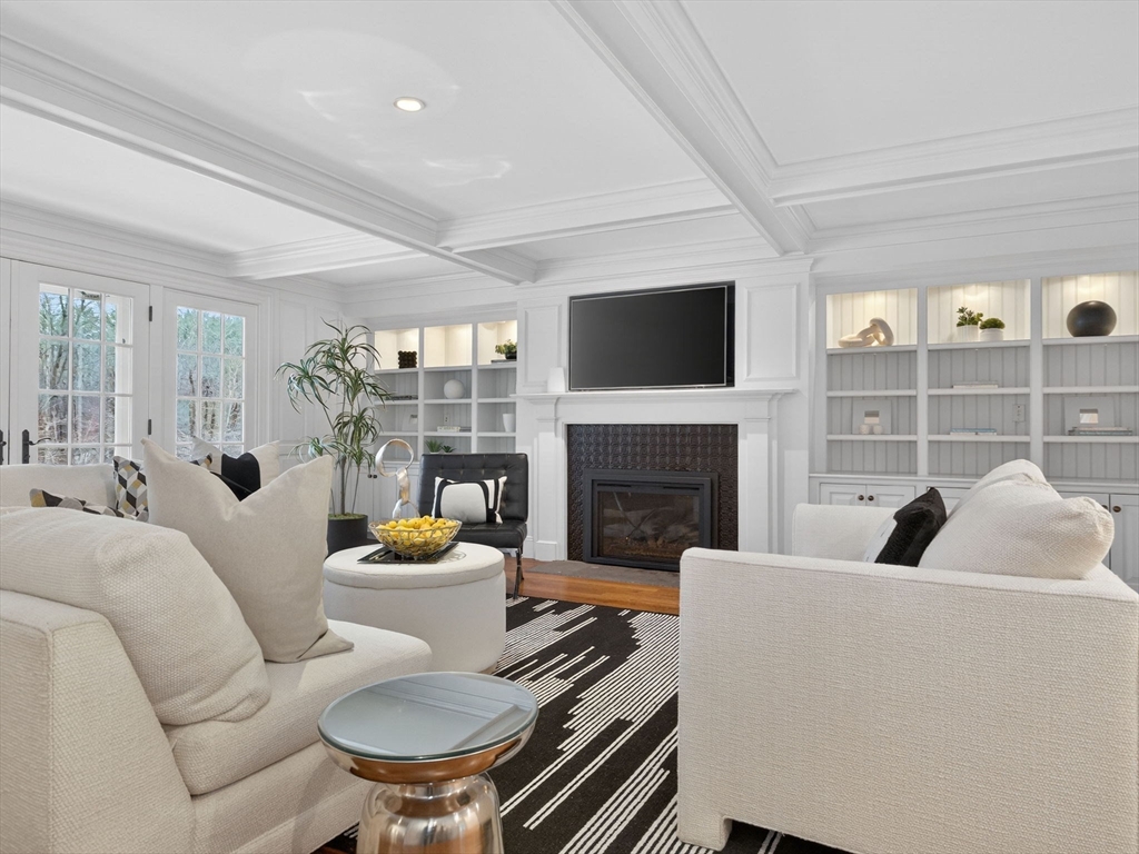 12 Winding River Circle Wellesley, MA 02482 - Photo 11 of 40 a living room with furniture a fireplace and a flat screen tv