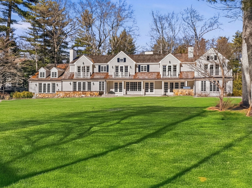 12 Winding River Circle Wellesley, MA 02482 - Photo 2 of 40 a view of a white house with a big yard and large trees