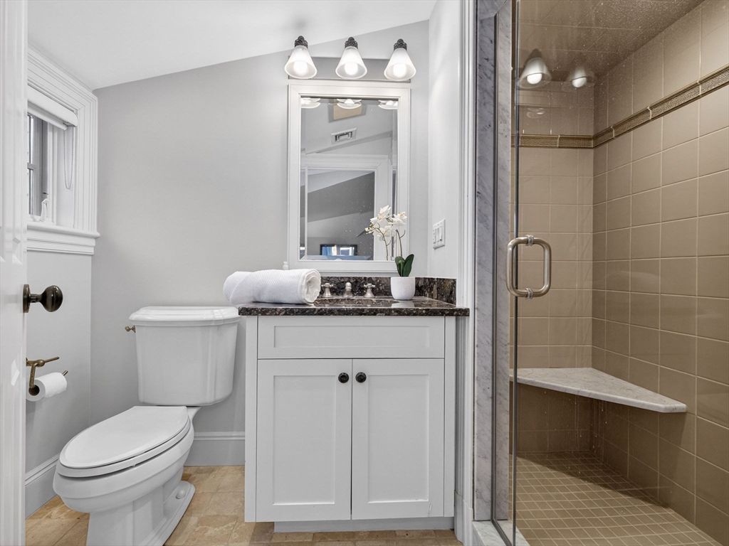 12 Winding River Circle Wellesley, MA 02482 - Photo 26 of 40 a bathroom with a granite countertop sink a toilet and a mirror