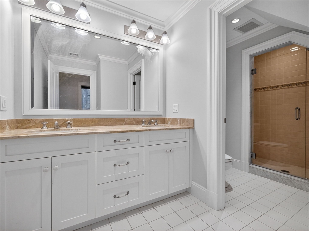 12 Winding River Circle Wellesley, MA 02482 - Photo 27 of 40 a bathroom with a granite countertop sink mirror and a shower