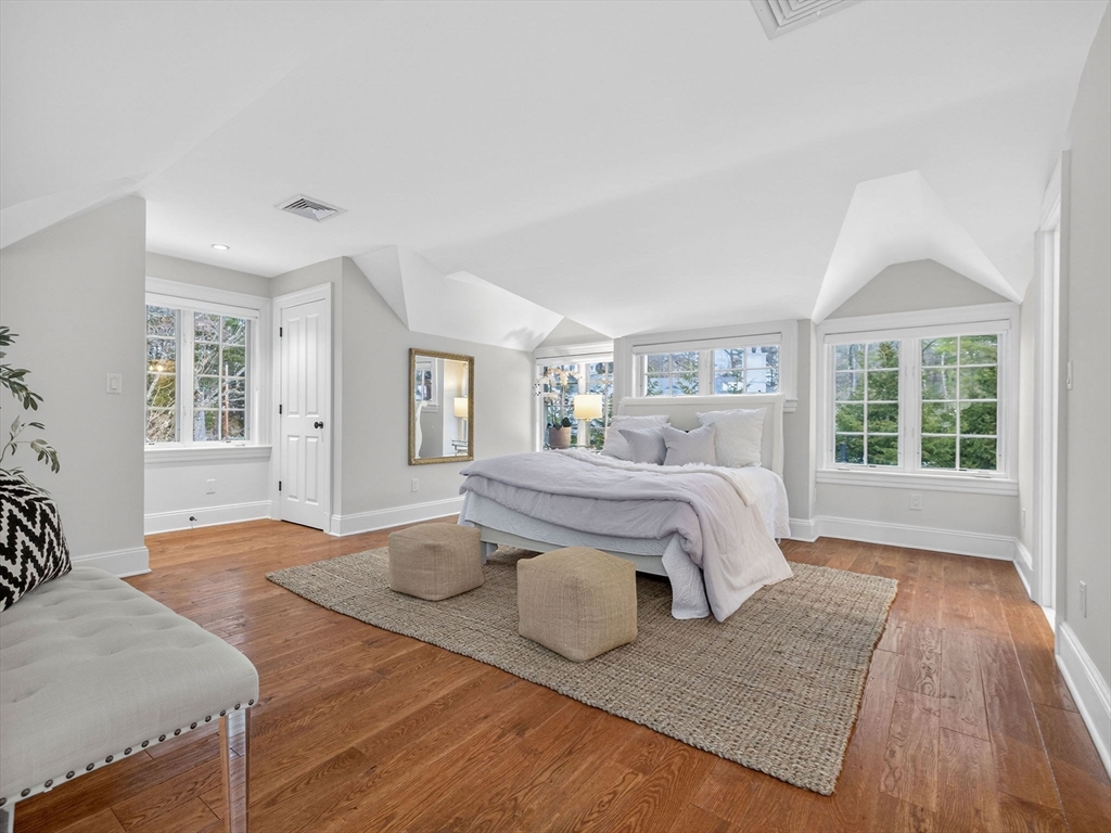 12 Winding River Circle Wellesley, MA 02482 - Photo 29 of 40 a bedroom with a large bed and wooden floor