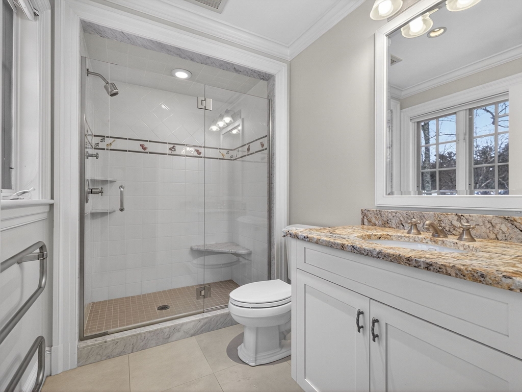 12 Winding River Circle Wellesley, MA 02482 - Photo 31 of 40 a bathroom with a granite countertop sink toilet a mirror and shower