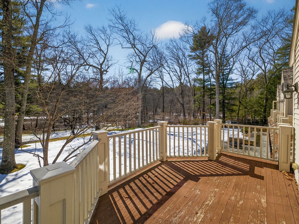 12 Winding River Circle Wellesley, MA 02482 - Photo 33 of 40 a view of a roof deck with wooden floor and fence