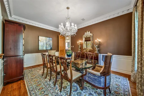 a view of a dining room with furniture and chandelier