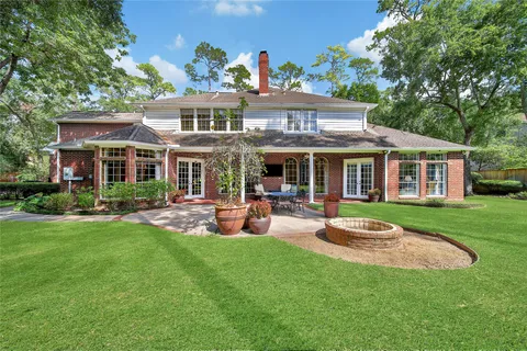 a view of a house with a yard and sitting area