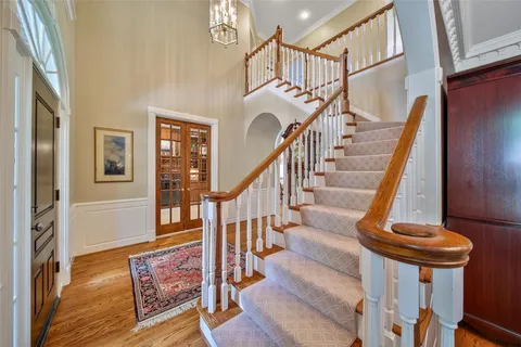 a view of entryway and hall with wooden floor