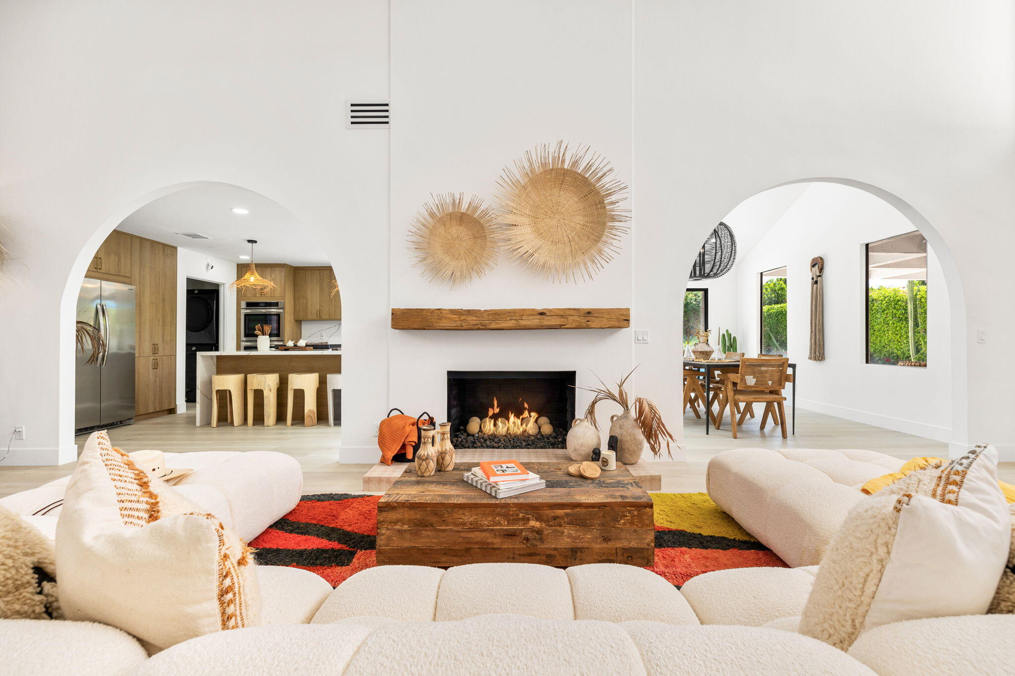 a living room with furniture fireplace and a large window
