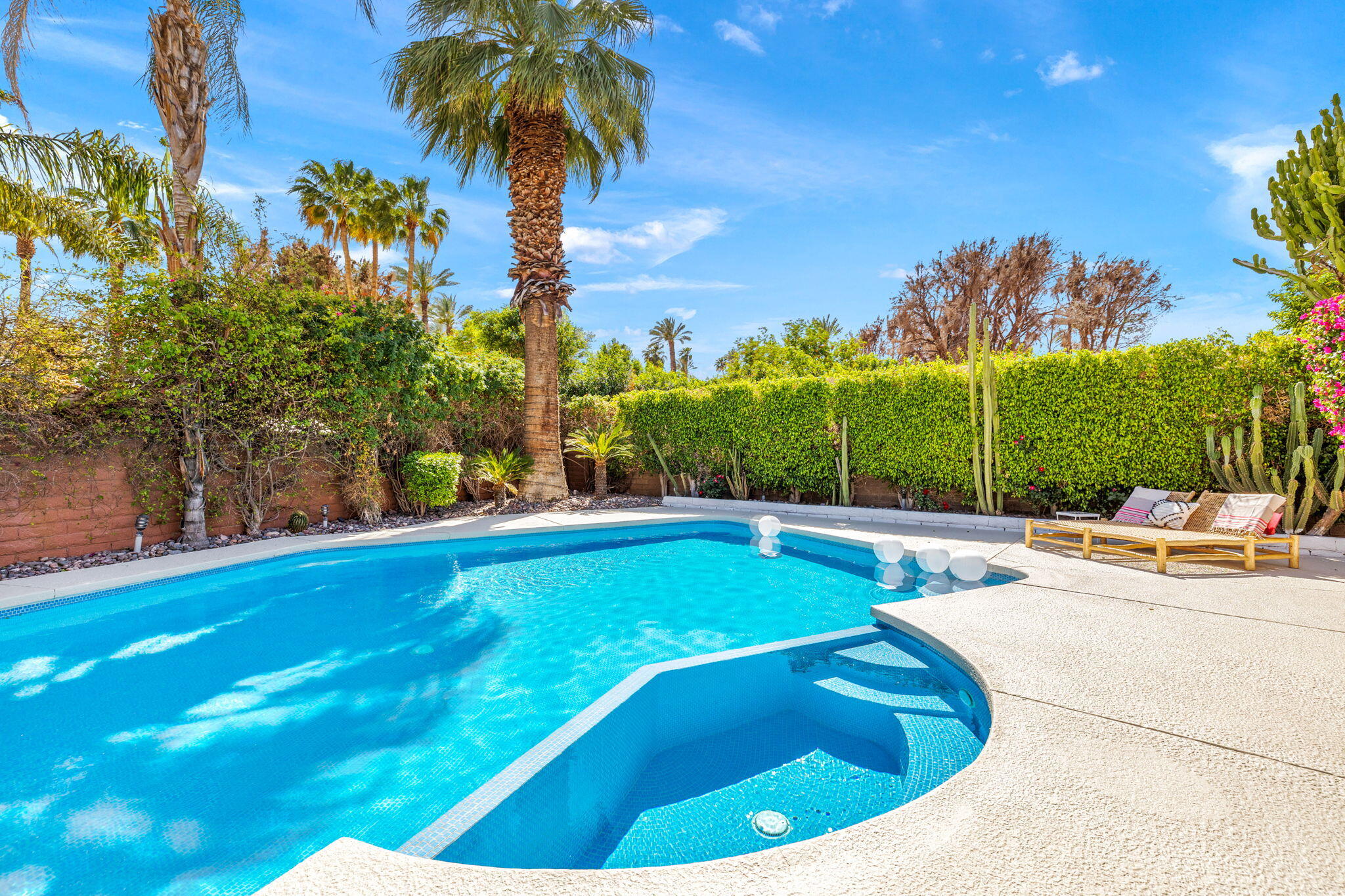 34 Lincoln Place Rancho Mirage, CA 92270 - Photo 45 of 52 a view of a swimming pool with a yard and palm trees