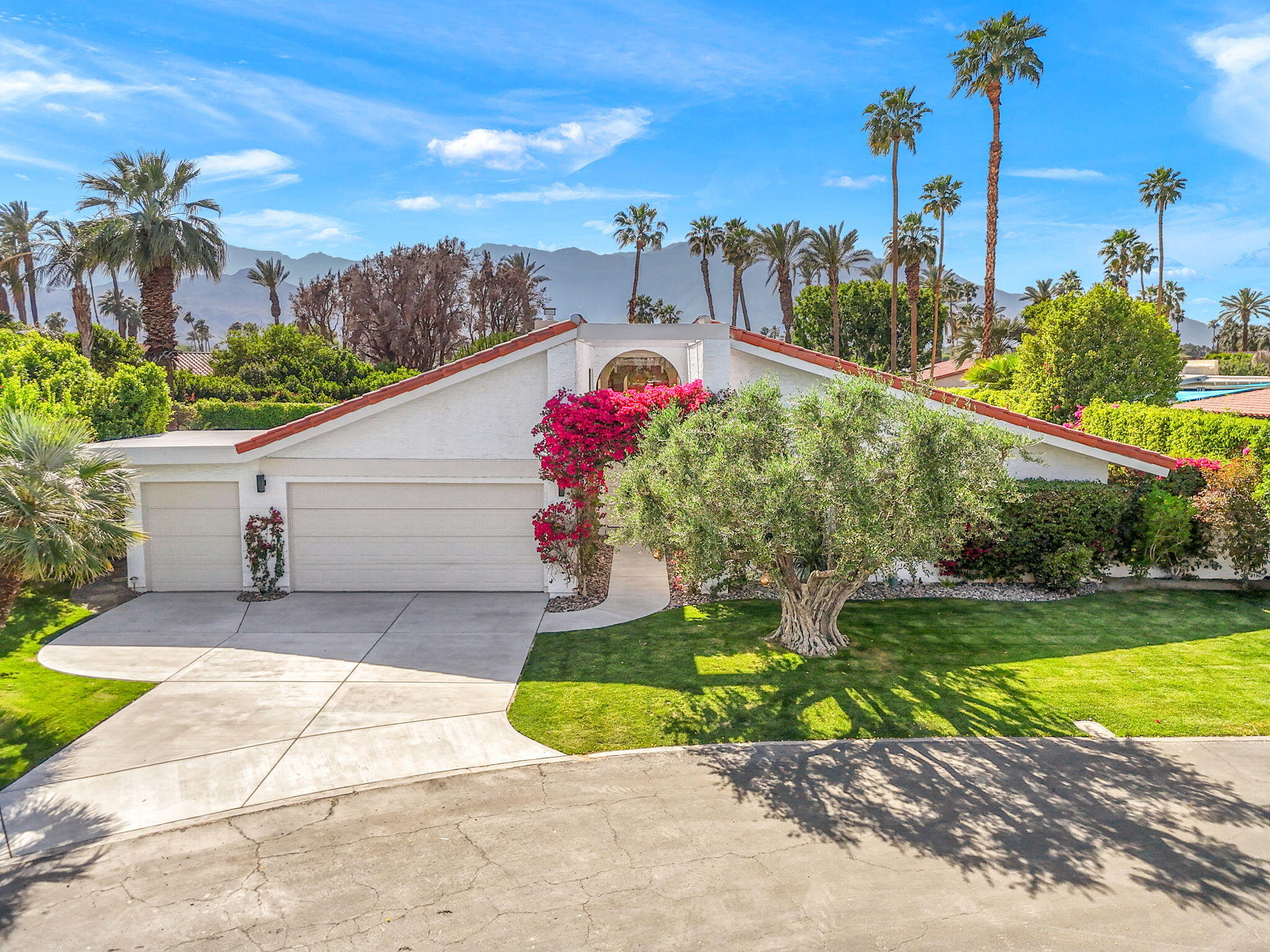 34 Lincoln Place Rancho Mirage, CA 92270 - Photo 50 of 52 a front view of a house with a yard and potted plants