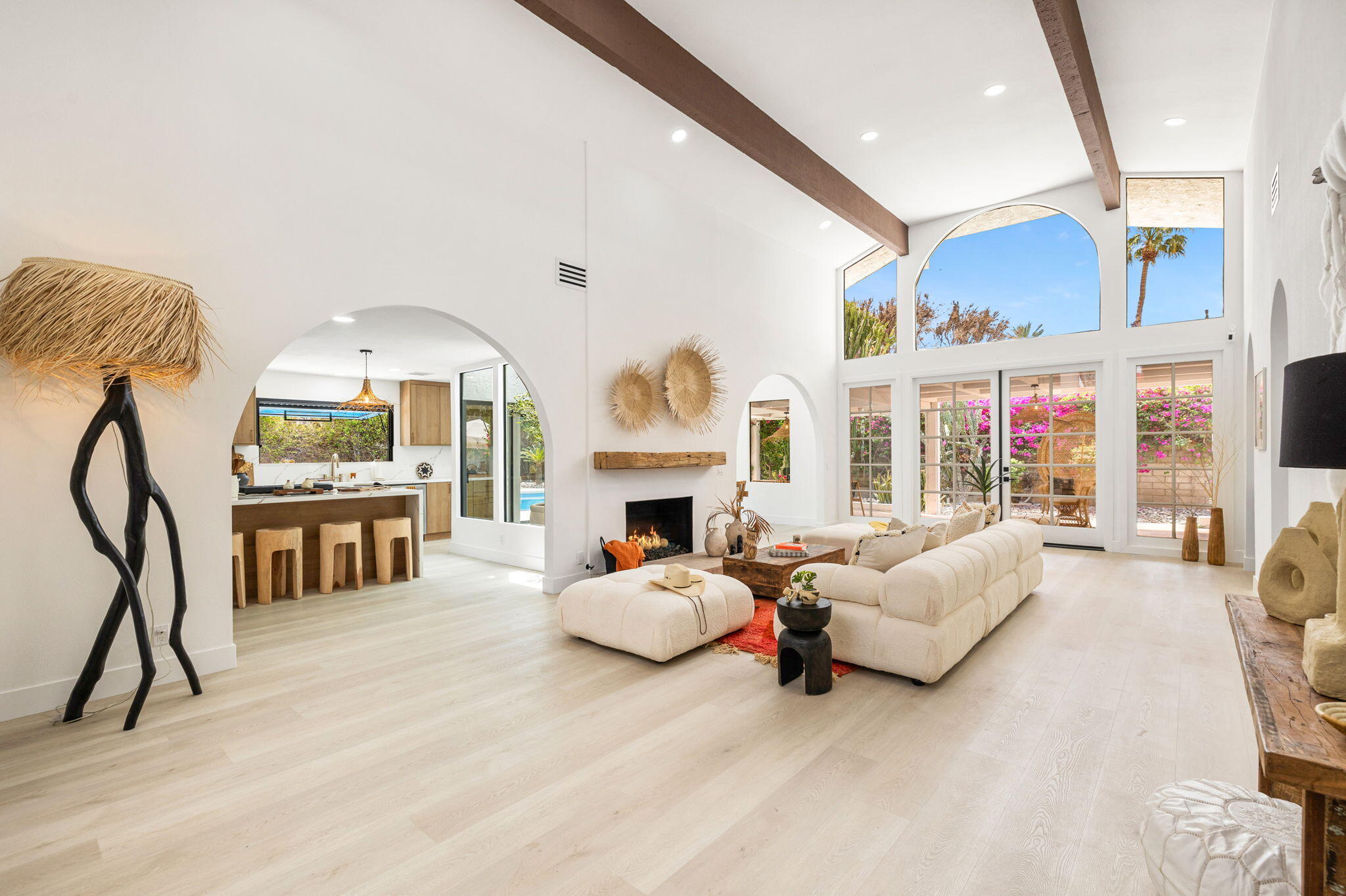 34 Lincoln Place Rancho Mirage, CA 92270 - Photo 5 of 52 a living room with furniture a fireplace and a floor to ceiling window