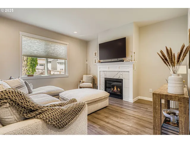 a living room with furniture fireplace and flat screen tv