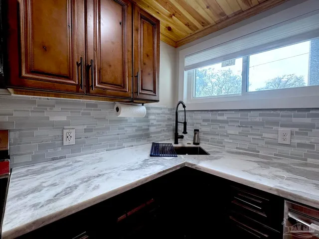 a view of a kitchen with a sink refrigerator and wooden floor
