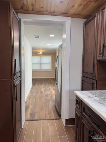 an empty room with wooden floor and a window