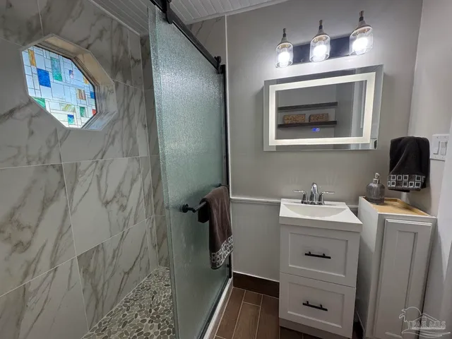 a bathroom with a bathtub and shelf
