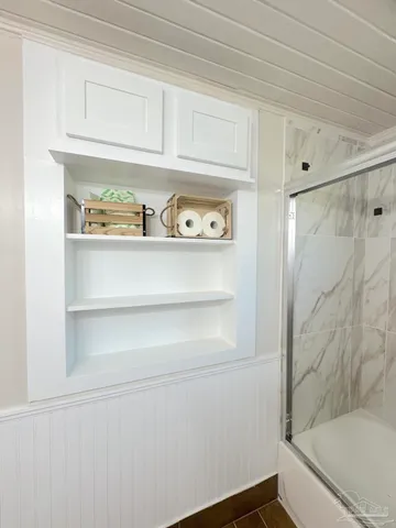 a bathroom with a sink a mirror and a shower