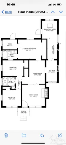 a view of an empty room with a fireplace and cabinets