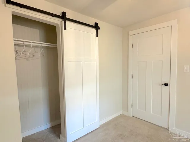 a view of room with stainless steel appliances wooden floor and a window