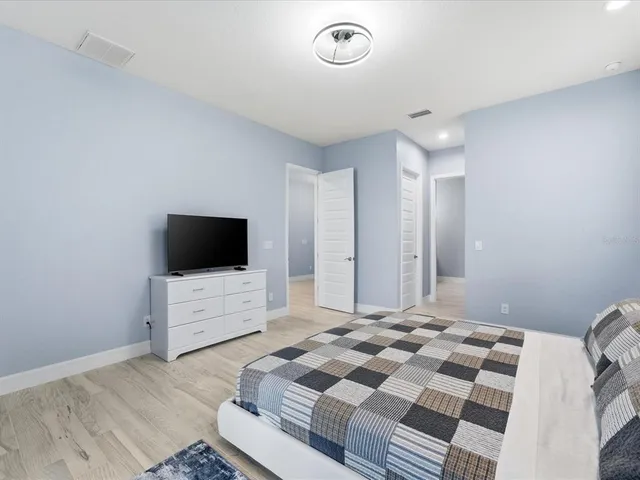 a bedroom with a bed and a flat screen tv