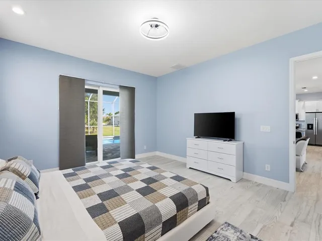 a bedroom with a bed and a flat screen tv