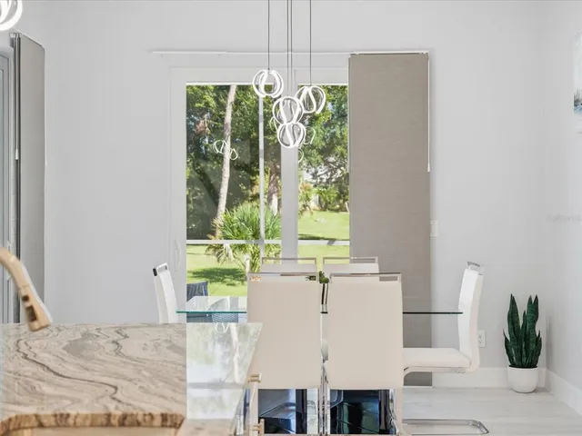 a living room with a large window a table and chairs