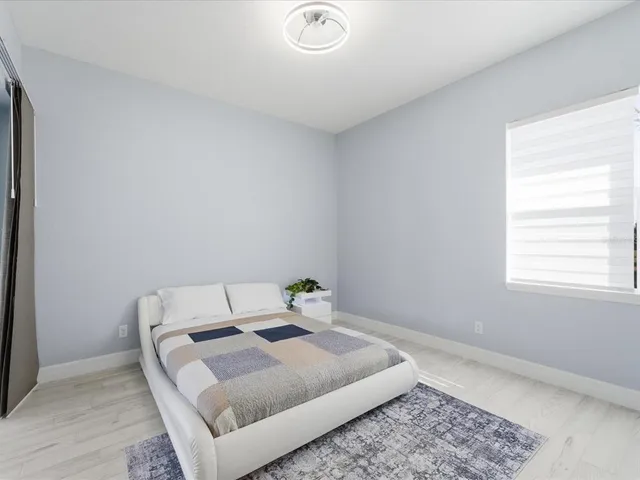 a bedroom with a bed and window