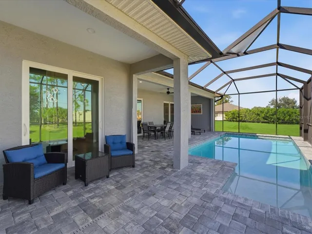 a view of a porch with furniture and a backyard