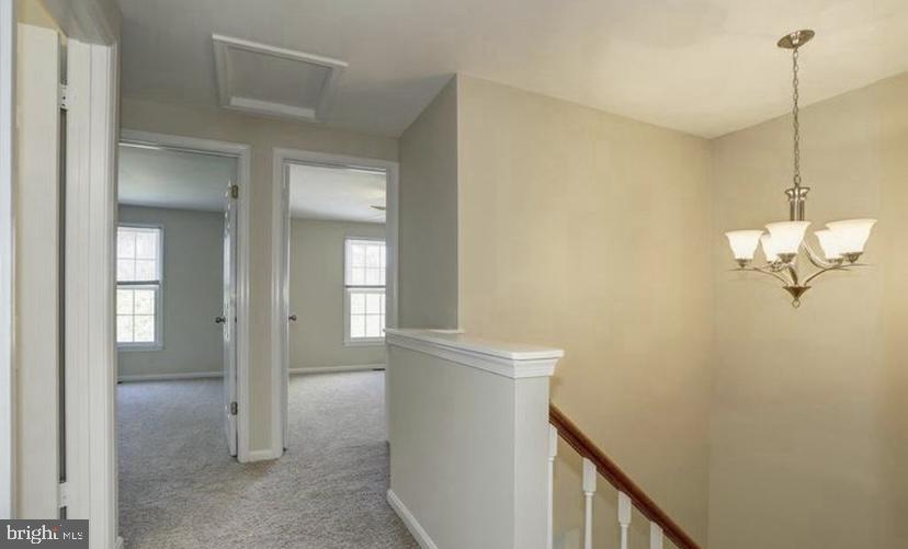 613 Concerto Lane Silver Spring, MD 20901 - Photo 11 of 23 a view of a hallway with closet and wooden floor