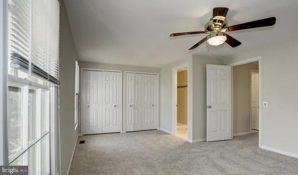 a view of empty room with ceiling fan