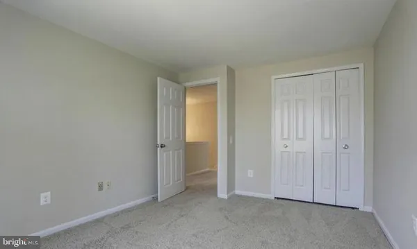 an empty room with closet area