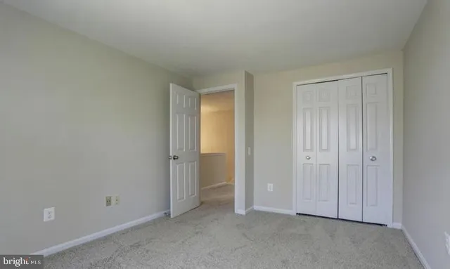 an empty room with closet area