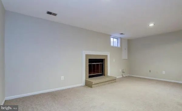 a view of an empty room with a fireplace