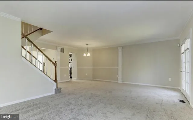 a view of an empty room with stairs