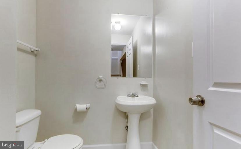 613 Concerto Lane Silver Spring, MD 20901 - Photo 10 of 23 a bathroom with a sink toilet and mirror
