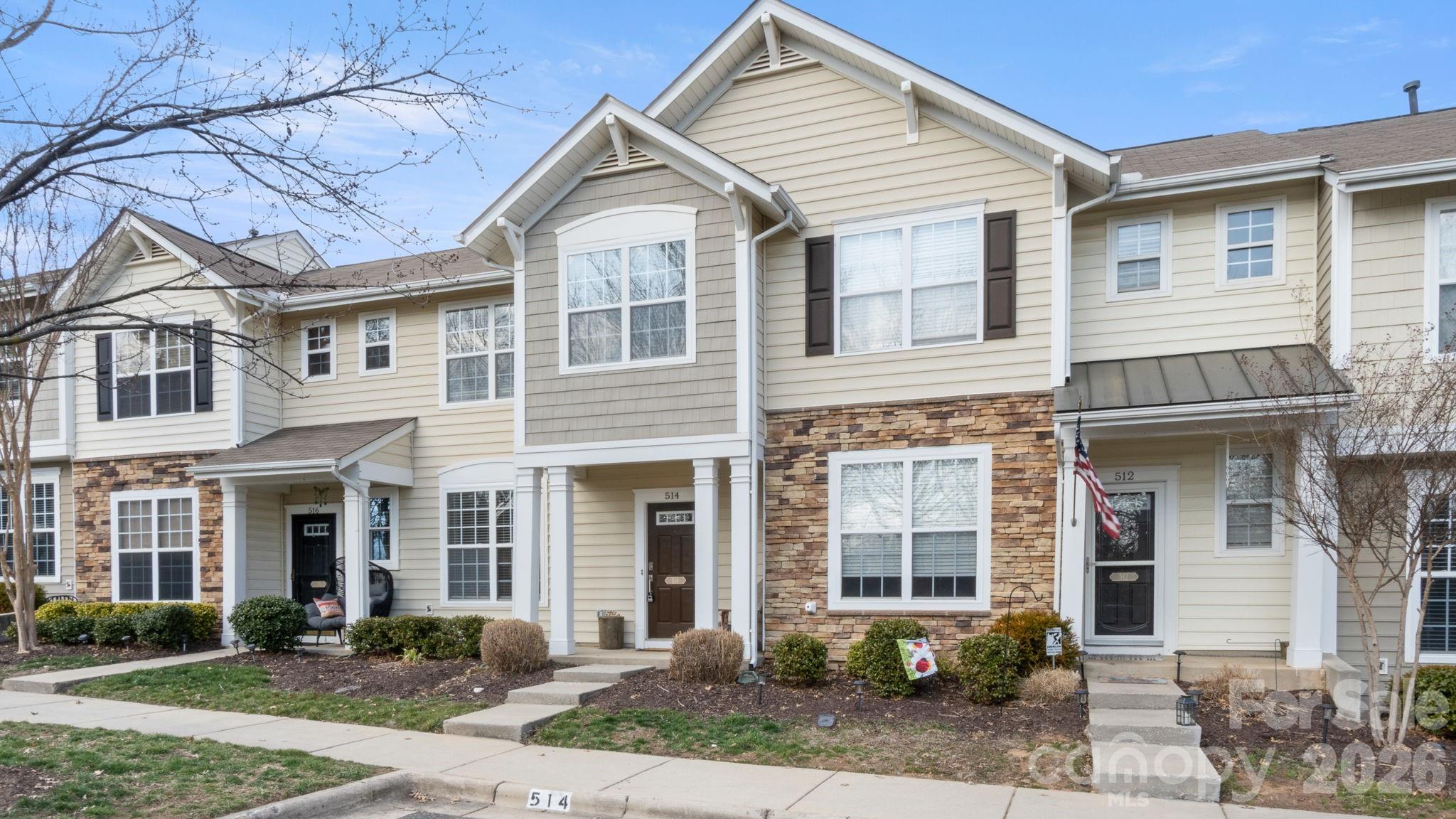 a front view of a house with garden and plants