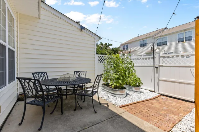 a view of a backyard with furniture and a garden