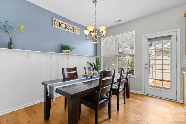 a view of a dining room with furniture and a chandelier