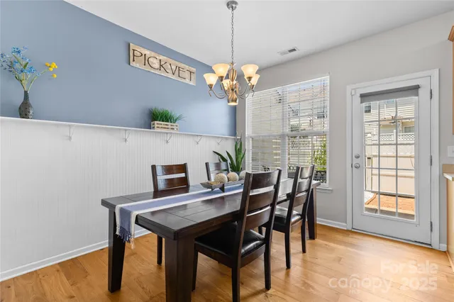a view of a dining room with furniture and a chandelier
