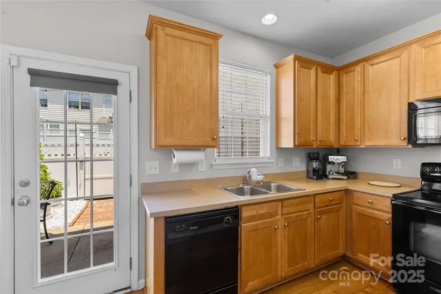 a kitchen with a sink stove and microwave