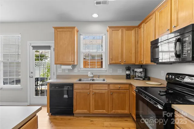 a kitchen with a sink stove top oven and cabinets