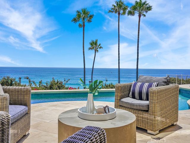 a view of a terrace with couches and sky view