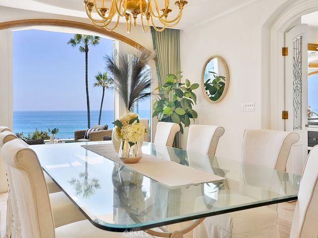 a dining room with furniture a chandelier and wooden floor