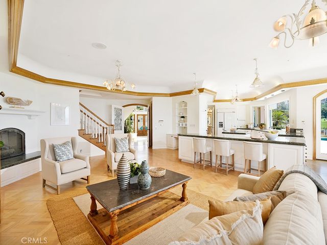 a view of a dining room with furniture a chandelier and wooden floor