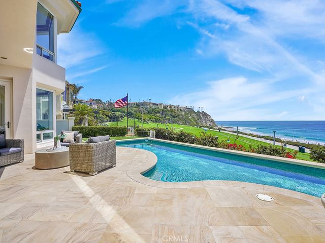 a view of a big building with a big yard and large trees