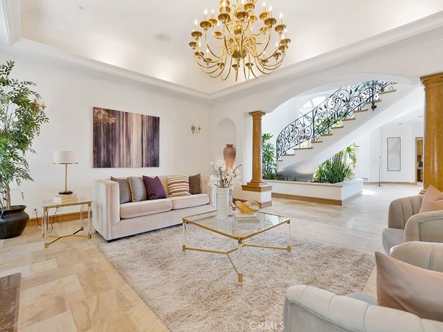 a living room with furniture a fireplace and a floor to ceiling window