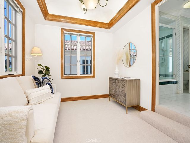 a spacious bedroom with a bed and large windows