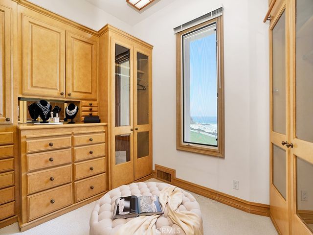 a living room with furniture a flat screen tv and kitchen view