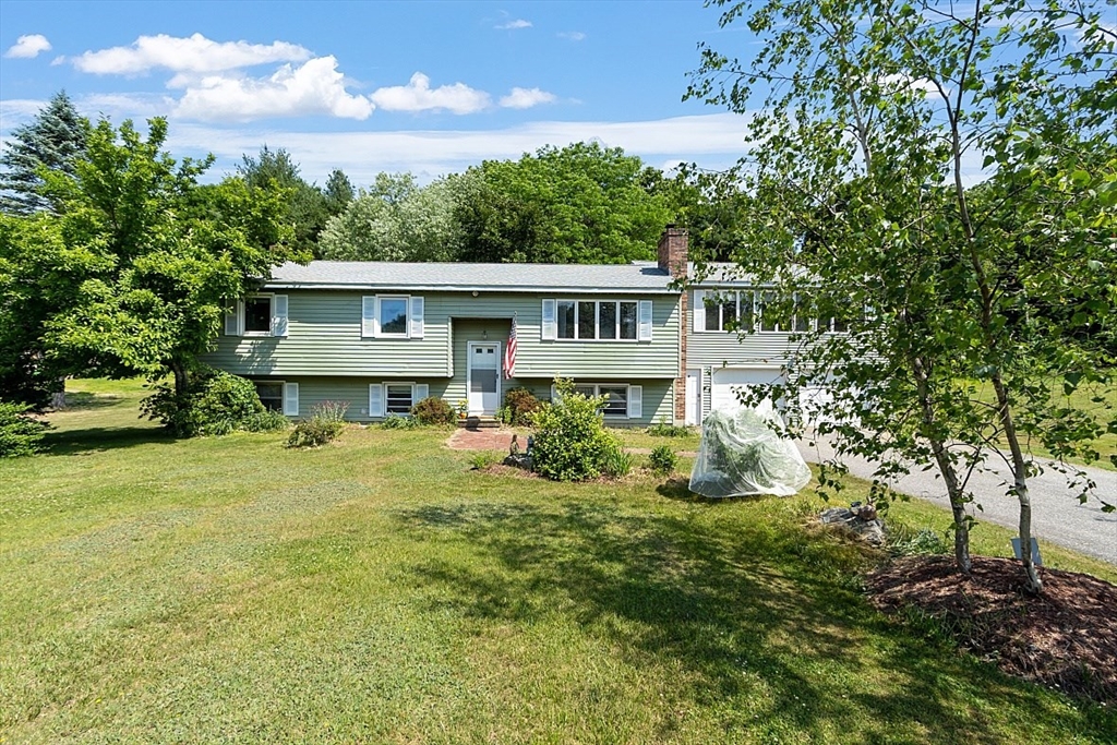 4 Ridgemont Drive Londonderry, NH 03053 - Photo 1 of 33 a front view of a house with a yard