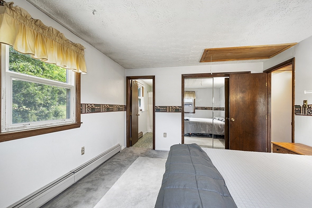 4 Ridgemont Drive Londonderry, NH 03053 - Photo 16 of 33 a bedroom with a bed and a large window