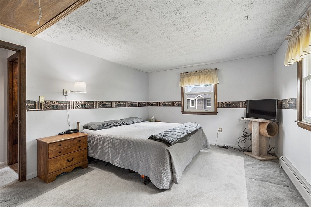 4 Ridgemont Drive Londonderry, NH 03053 - Photo 17 of 33 a spacious bedroom with a bed and a window